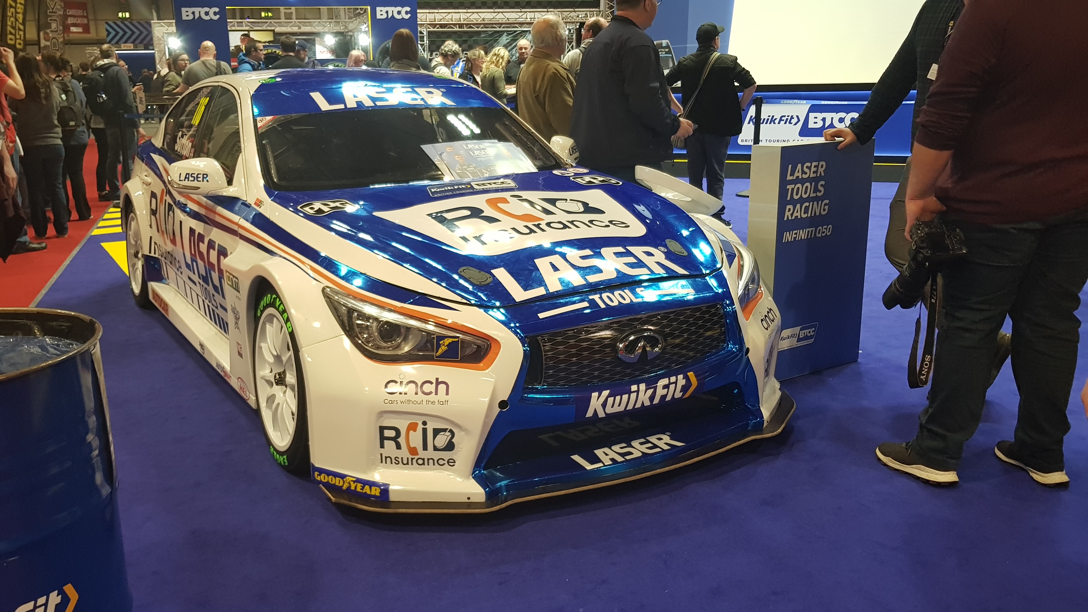 Front 3/4 photo of a white and blue Infiniti Q50 indoors at the NEC during the 2020 Autosport International Show