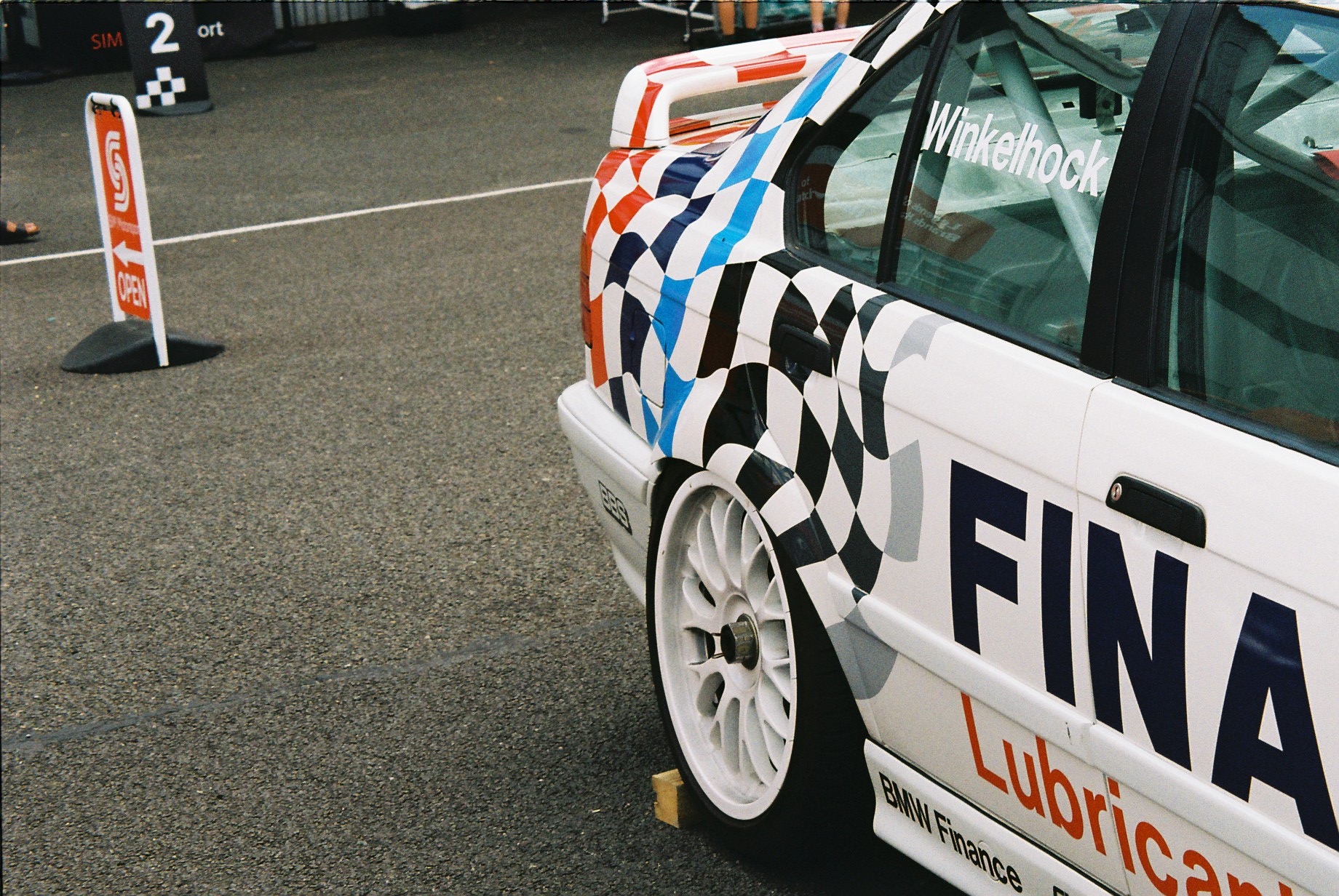 A close up photo of the side of a BMW 318i E36 Super Touring car